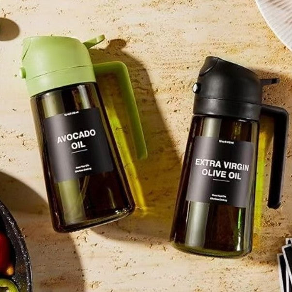 AeroMist light-shielding glass oil sprayers in black and green on a kitchen counter